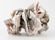 a pile of newspaper sitting on top of a white table