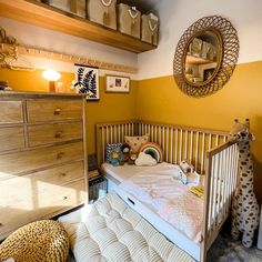 a baby's crib in the corner of a room next to a dresser