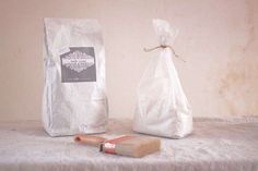 a bag and brush sitting on top of a table next to a white paper bag