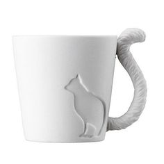 a white mug with a cat design on it