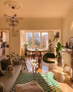 a living room filled with furniture and a fire place next to a dining room table