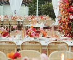 the tables are set with flowers and candles