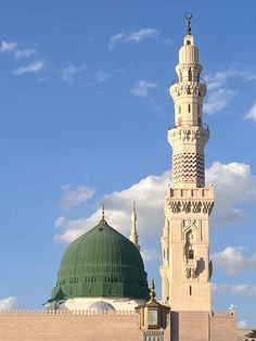 a tall white building with a green dome