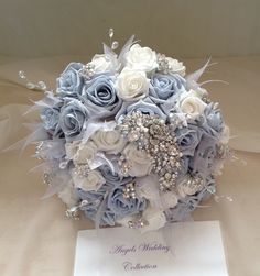 a bridal bouquet with blue and white flowers