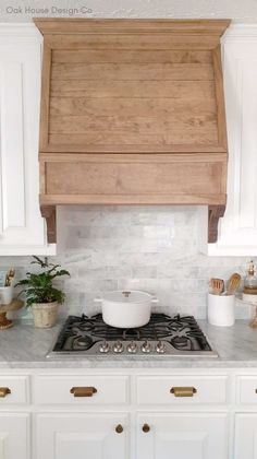 a stove top oven sitting inside of a kitchen next to white cabinets and counter tops