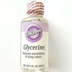 a bottle of glycerine sitting on top of a white table