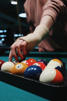 a pool table with several billiards and eight ball balls lined up on it