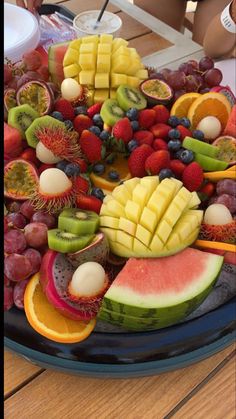 a platter filled with lots of different types of fruit