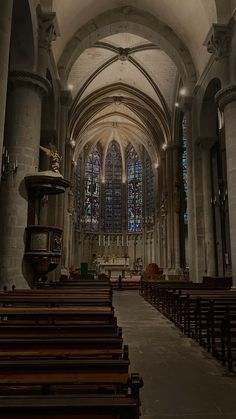 an empty church with pews and stained glass windows