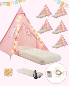 a pink tent with lights on it and some mattresses in front of the tent