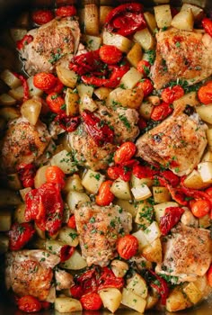 chicken, potatoes and tomatoes in a pan with seasoning