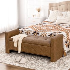 a bed sitting on top of a wooden floor next to a window