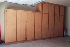 an empty room with wooden cabinets in it