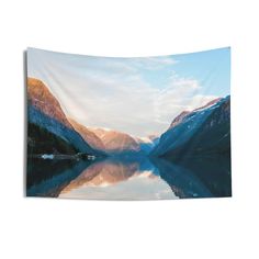 a lake with mountains in the background and water reflecting it's reflection on the surface