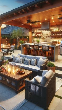 an outdoor living area with couches, table and grill in the background at dusk