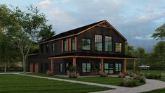 a large black house with lots of windows on the front and side of it, surrounded by lush green grass