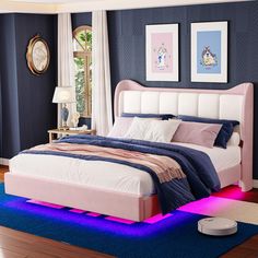 a bedroom with blue walls and pink bedding, white headboard and foot board