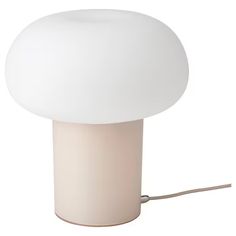 a white table lamp with a cord attached to it