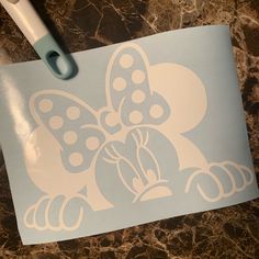 a mickey mouse stencil sitting on top of a table next to a pen