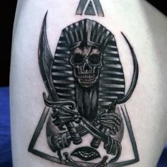 an egyptian tattoo with a skull and two swords