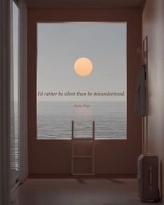 an open window with a quote on it in front of the ocean and a ladder