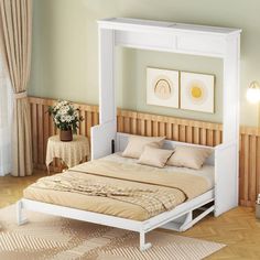 a white bed sitting in a bedroom next to a wooden table and chair on top of a hard wood floor