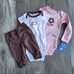 3 Piece Daddy Loves Me Set, Includes Chocolate And Pink Polka Dot Pants With Cuff At Ankle, A Short Sleeve Onesie With Embroidery And A Long Sleeve Onesie With Flower And Scratch Mittens! Playful Pink Cotton Pants, Fitted Cute Pink Pants, Cute Fitted Pink Pants, Cute Pink Fitted Pants, Pink Cotton Playwear Pants, Pink Cotton Pants For Playtime, Pink Cotton Pants For Playwear, Cute Pink Cotton Pants, Cute Pink Bottoms For Playtime