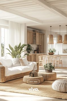 a living room filled with lots of furniture and plants on top of rugs in front of windows