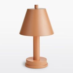 an orange table lamp with a beige shade on the base and a light brown shade on the top