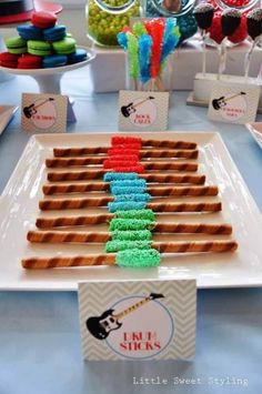 there is a plate that has some food on it and candy sticks in the shape of a christmas tree