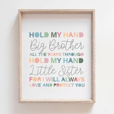 a wooden frame hanging on the wall with a quote in it that says hold my hand, big brother all the years through