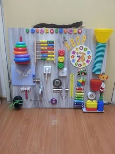 a child's play area with toys and magnets on the wall, including a clock