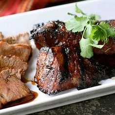 some meat is on a plate with garnishes and parsley in the middle