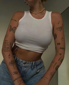 a woman with tattoos on her arms and chest