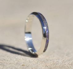 a close up of a ring on the ground with sand in front of it,