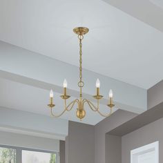 a chandelier hanging from the ceiling in a room with white walls and windows