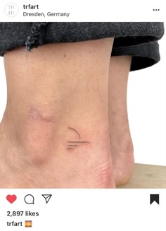 a person with a small tattoo on their foot and the bottom part of her leg