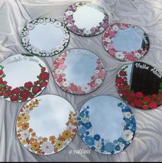 six mirrors with flowers painted on them