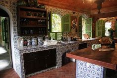 a kitchen with an island in the middle and lots of counter space on each side