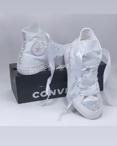 Rhinestone Custom CONVERSE HI TOPS in all white canvas. *DESIGN for this listing: 💎 These Custom Jeweled Chucks Shine like DIAMONDS with CRYSTAL CLEAR premium rhinestones 💎 TOES completely covered in clear gems 💎 HEELS with 3 rows of crystals down the back 💎 Crystals on the logos on the inner 2 sides - around the circle and the star 💎 Small laces loop blinged out as shown on top of tongue 💎 Comes laced with beautiful white ribbon, with original laces included in the shoebox *Additional Fees for ADD-ONS such as : Personalizations on the two outer sides (an ex. name is shown, dates, scattering crystals, hearts, etc. Message if you'd like to discuss your design and set up a custom order. Prices will vary by design. *Crystal color: Comes with CLEAR DIAMOND, however, other colors are avai Converse Quinceanera Shoes, Quince Converse, Bedazzled Converse, Sparkle Converse, Personalized Converse, Rhinestone Converse, Bridal Converse, Converse Wedding Shoes, Converse Hi