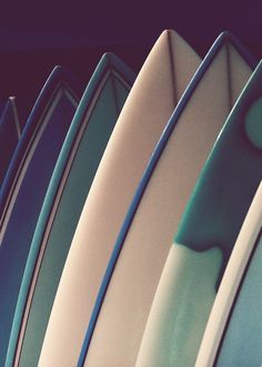 several surfboards are lined up in a row