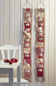 two red and white wall hangings with apples on them