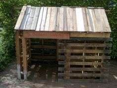 a wooden shelter with a sign that says the buddha's cabin on it in front of some bushes