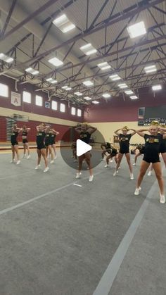 a group of cheerleaders performing in a gym