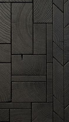 a close up view of black wood textured wallpaper or flooring with wavy lines