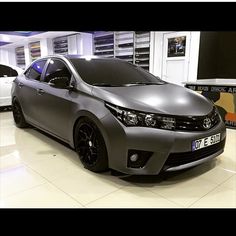 a silver car is parked in a showroom