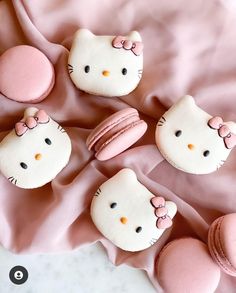 hello kitty macaroons are laying on a pink blanket