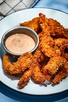 some fried food on a plate with dipping sauce