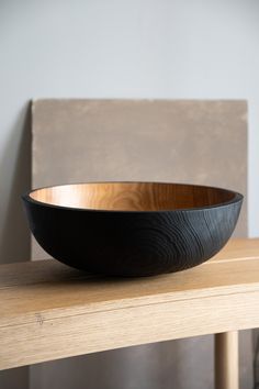 a wooden bowl sitting on top of a table