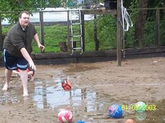 a man is playing with balls in the mud